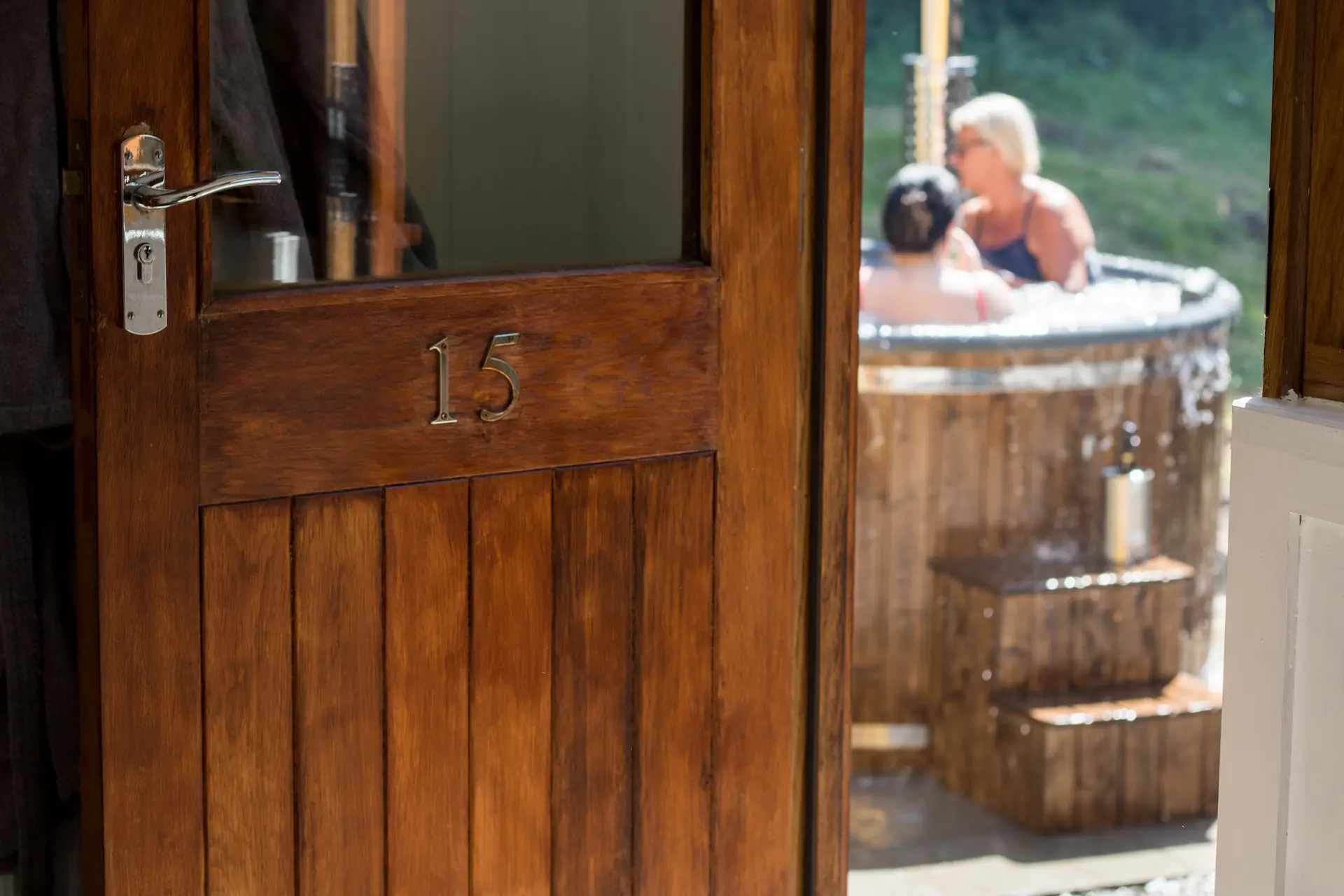 People in hot tub viewed through a half-open door
