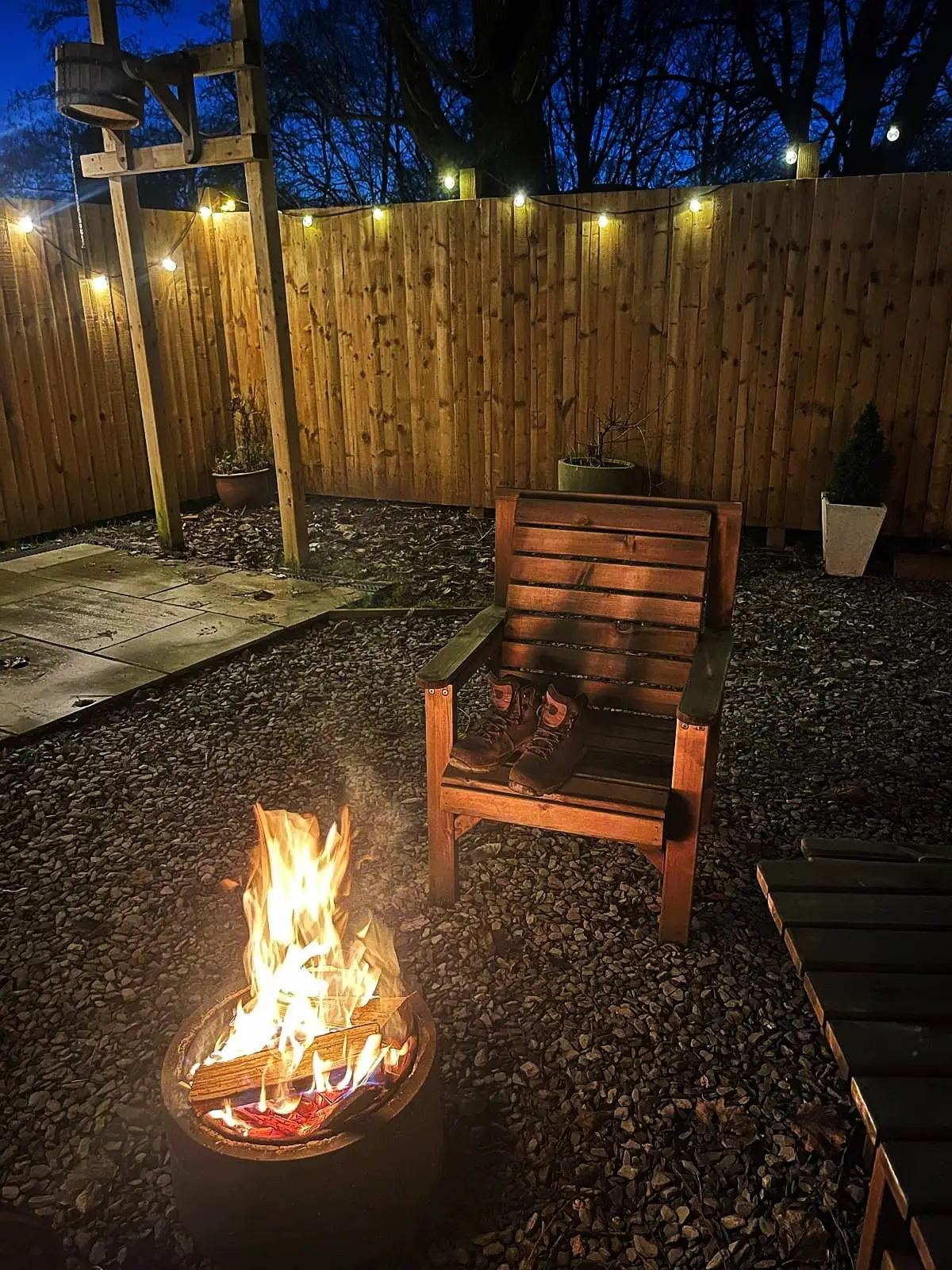 Firepit with blazing fire and chair